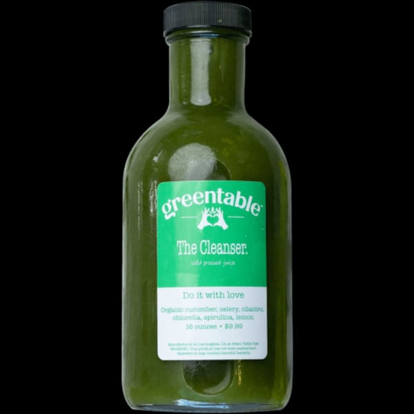 Green Table Cafe's "The Cleanser" cold-pressed juice bottle with a green label on a black background.