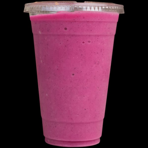 Vibrant pink smoothie in a clear plastic cup with a lid, from Green Table Cafe.
