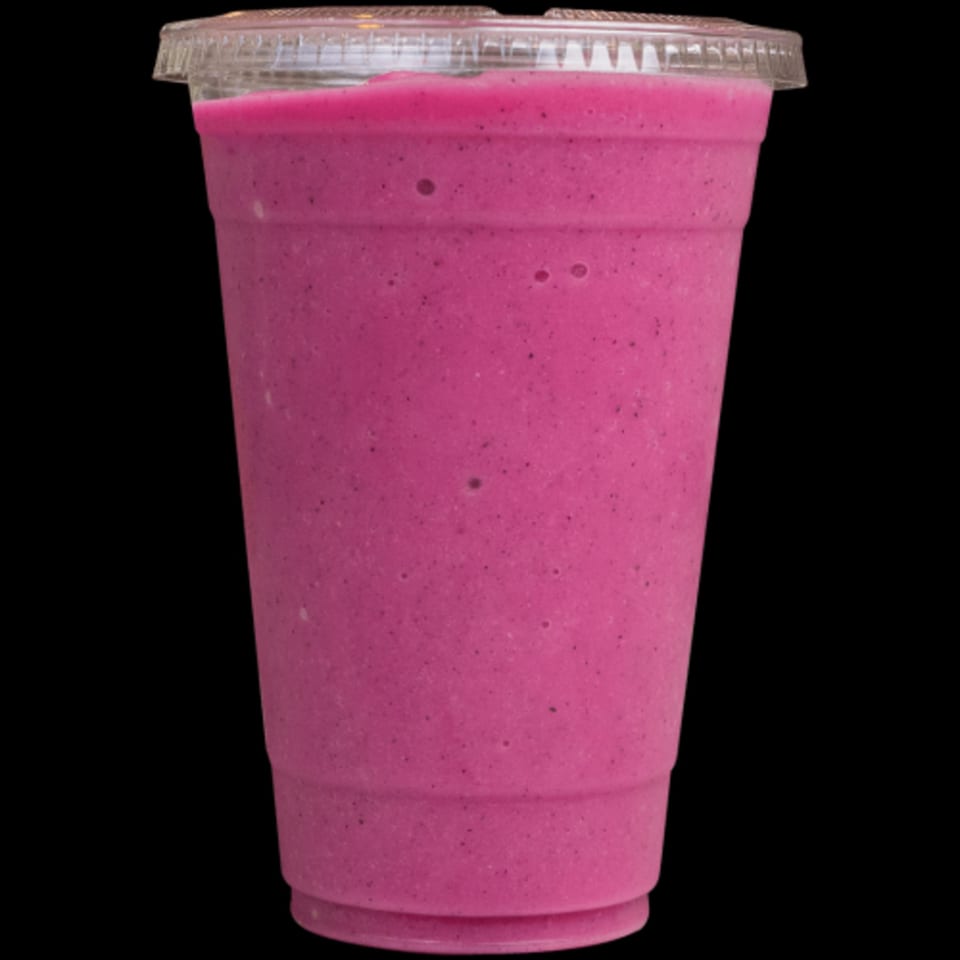 Vibrant pink smoothie in a clear plastic cup with a lid, from Green Table Cafe.