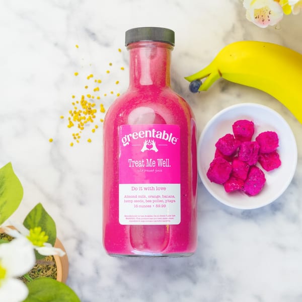 Green Table Cafe's pink "Treat Me Well" cold-pressed juice with pitaya, banana, and bee pollen.