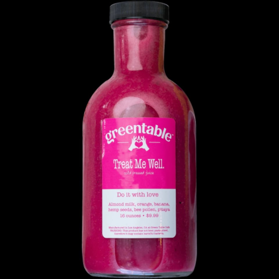 A bottle of Green Table Cafe's "Treat Me Well" cold-pressed juice, a vibrant pink blend.